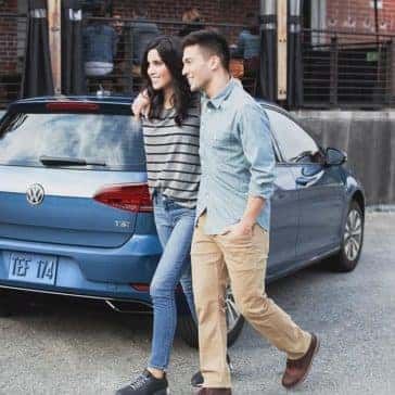 Couple walking past 2018 Volkswagen Golf