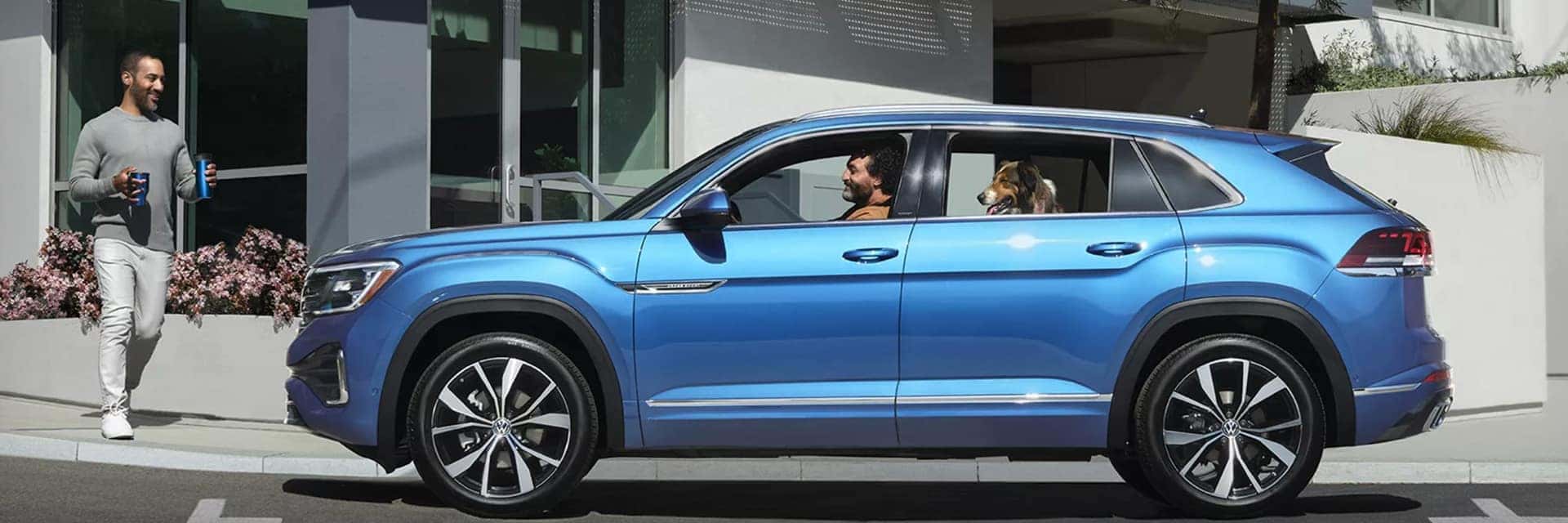 blue 2025 volkswagen atlas cross sport with family and dog