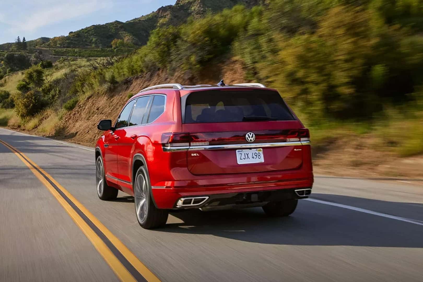 red 2025 volkswagen atlas driving on road