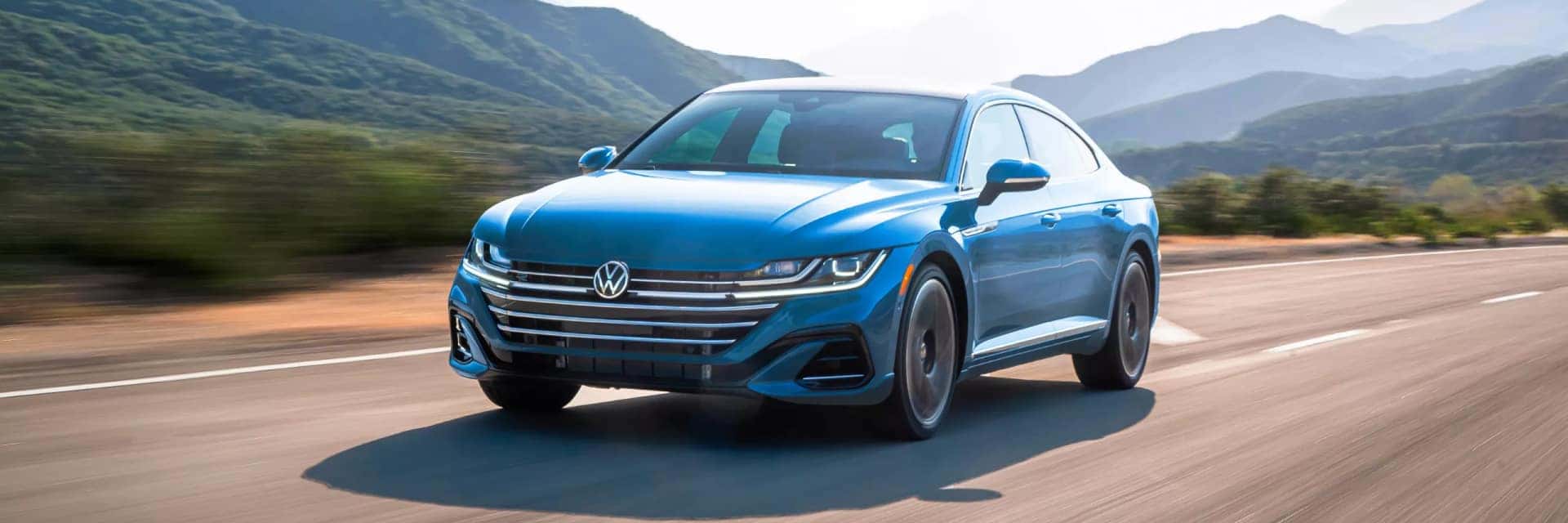 2023 vw arteon driving in front of mountains