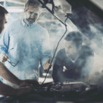 Men looking at car engine because it is overheating
