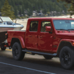 Jeep Gladiator towing a boat down the interstate.