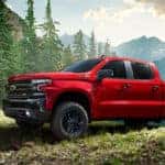 silverado special editiom truck in red driving in the fores