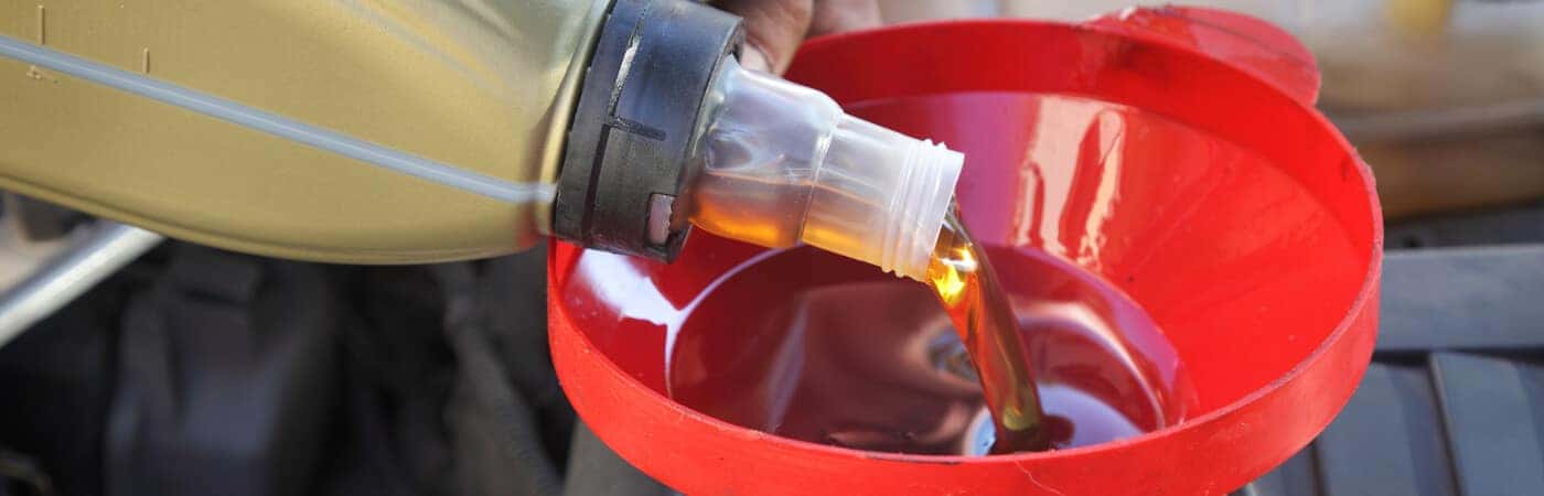 Oil being poured into engine cavity