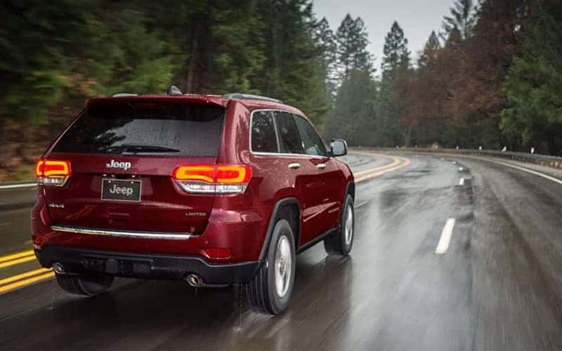 2019 Jeep Grand Cherokee driving on wet road