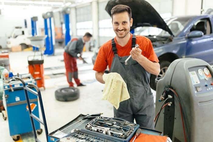 Technician standing near car