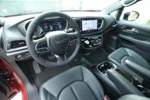 Interior view of the 2025 Chrysler Voyager showcasing a modern dashboard, digital instrument cluster, touchscreen infotainment system, and premium black seating.