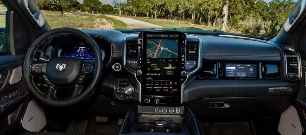  2025 RAM 2500 interior featuring a large touchscreen display, premium leather steering wheel, and advanced navigation system. Available now at Bernard of Northtown.
