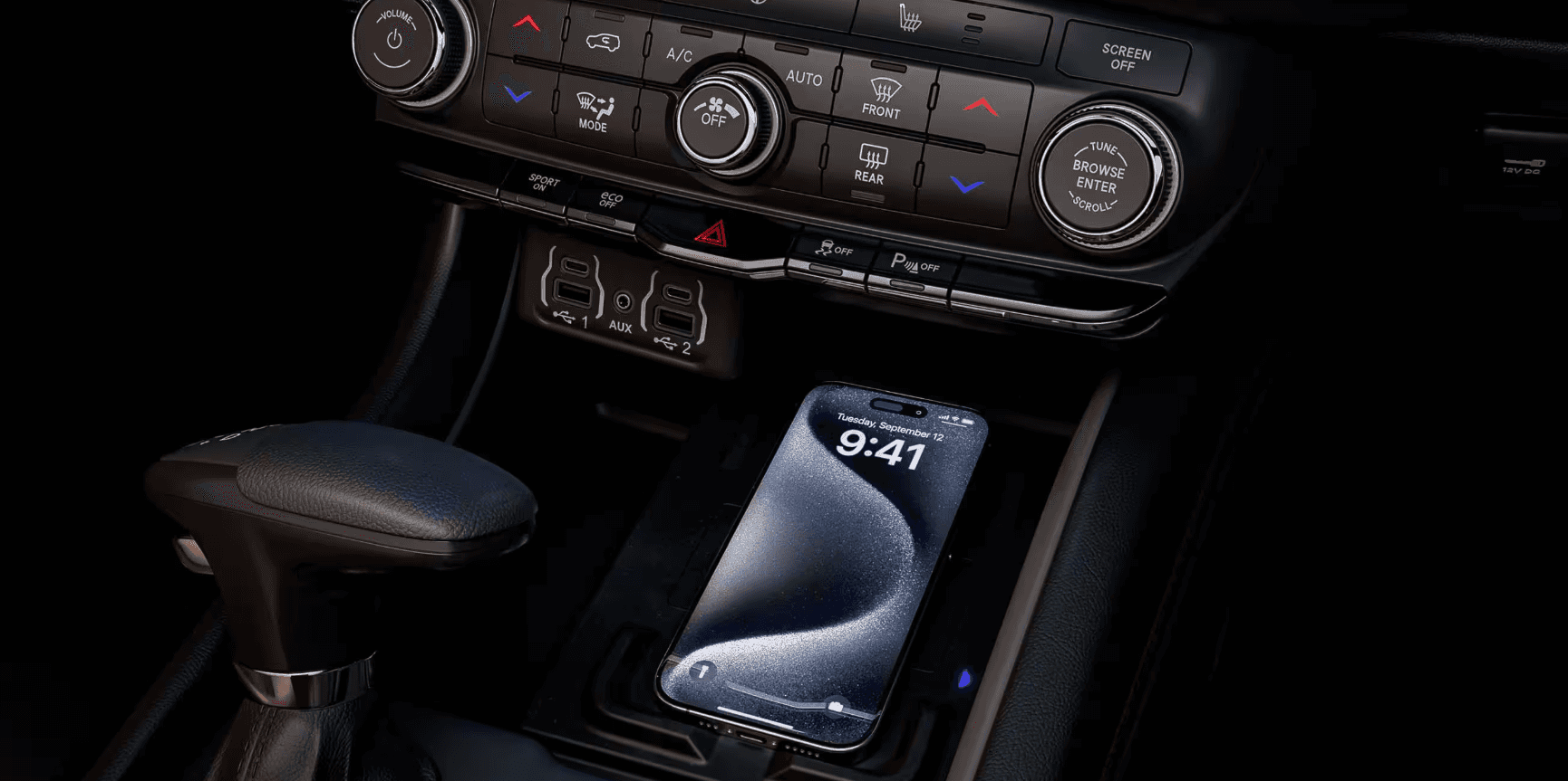 Close-up of the 2025 Durango center console with a phone on the wireless charging pad.