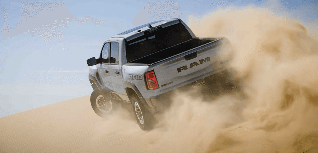The 2026 RAM 1500 RHO off-roading in the sand