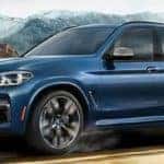 blue 2019 x3 driving on highway