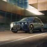 2026-BMW-iX-Driving-Down-the-Street-with-Motion-Blur