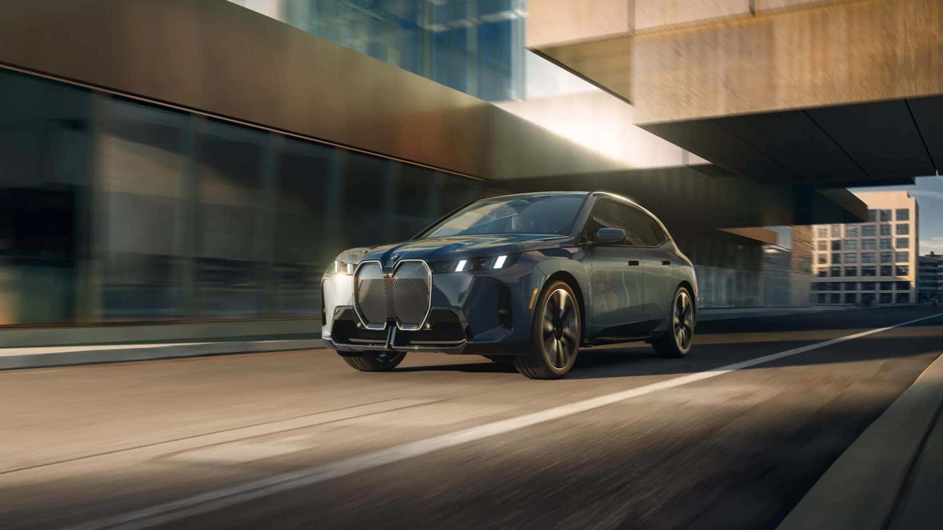 2026-BMW-iX-Driving-Down-the-Street-with-Motion-Blur