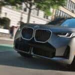 2026-BMW-X3-driving-down-city-road
