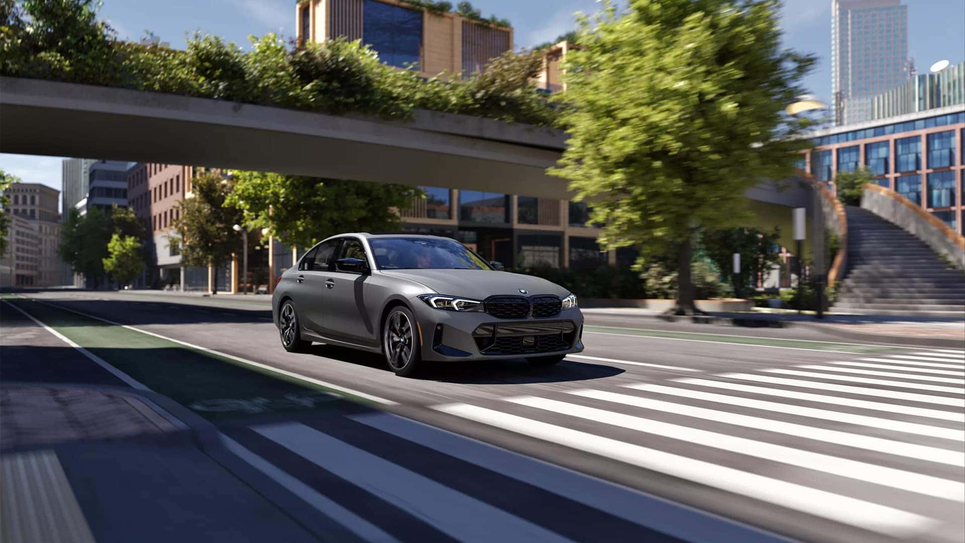 2026 BMW M3 driving down city street