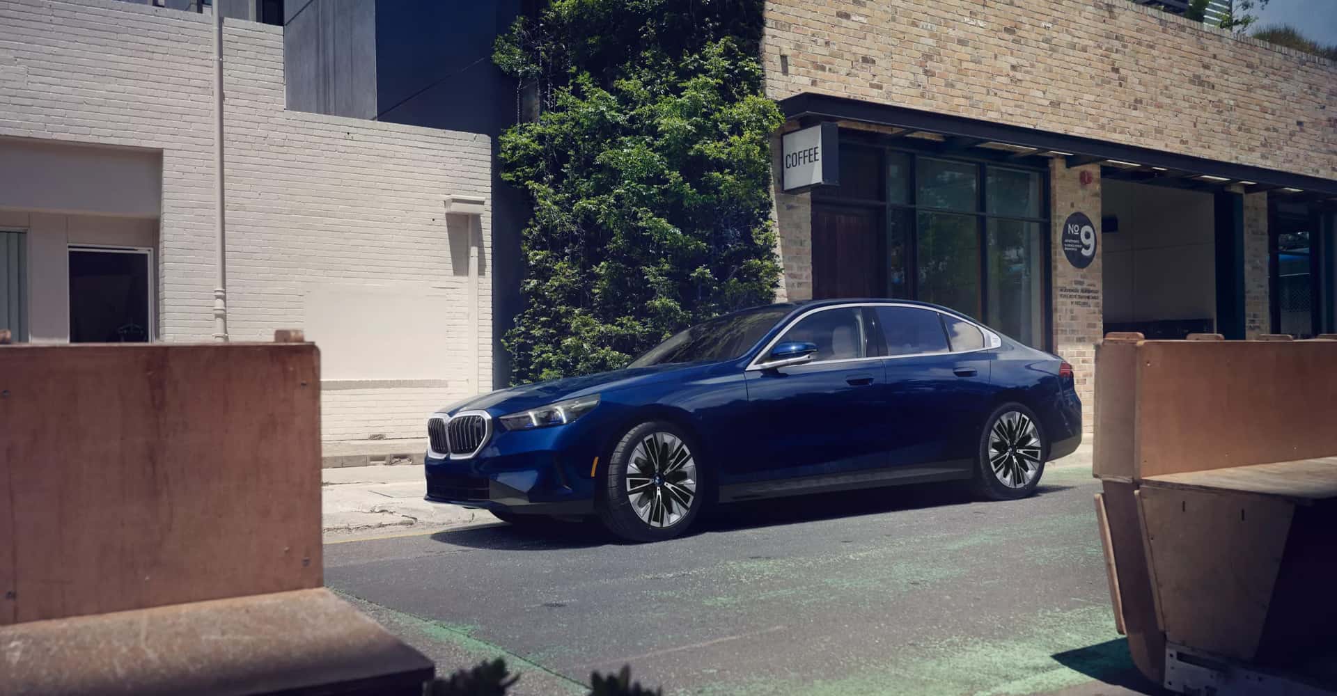 2026 BMW 5 Series driving down city street