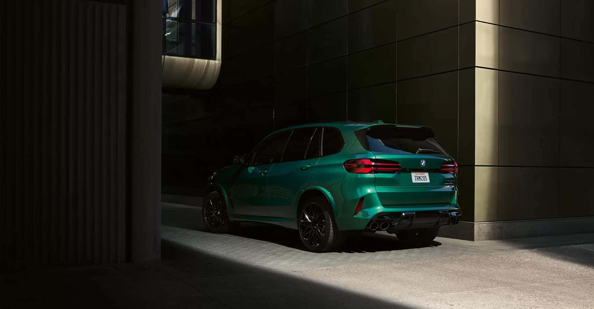 2026-BMW-X5M-green-rear-drivers-side