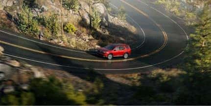 2024 Honda Pilot driving on a forest road with a natural backdrop. Danville, CA