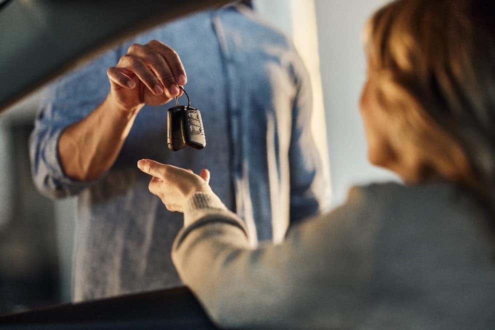 Honda Staff Member Handing Over The Key to a Woman in a Dealership in Danville, IL