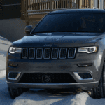 2021 Jeep Grand Cherokee driving through snow.