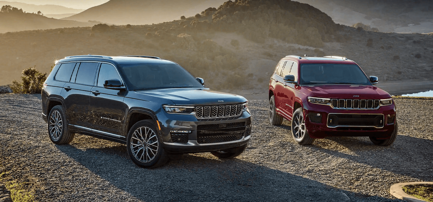Two 2021 Jeep Grand Cherokee L vehicles parked in the desert.