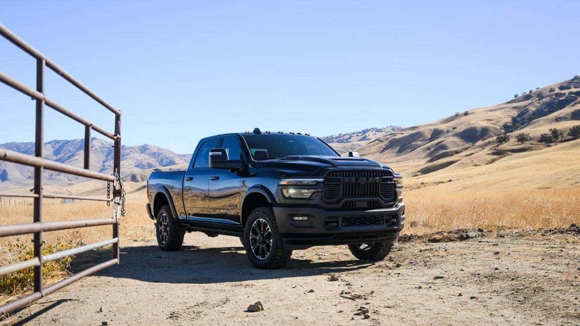 A black RAM 2500 parked on a ranch in a desert.