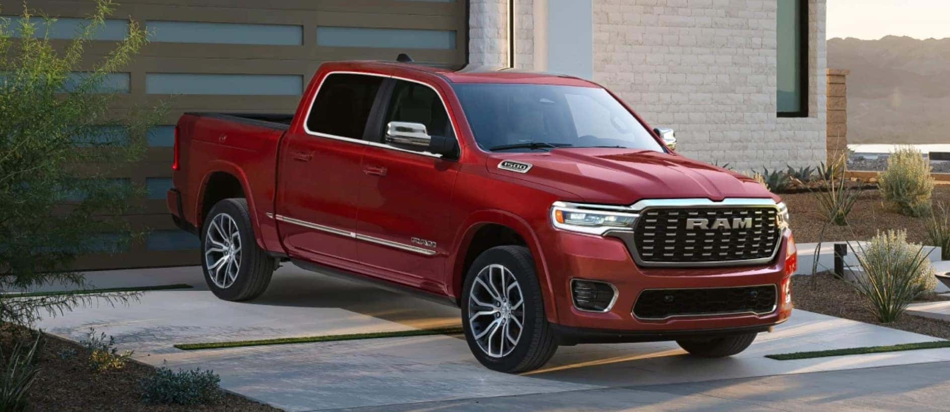 A red RAM 1500 parked in a house's driveway.