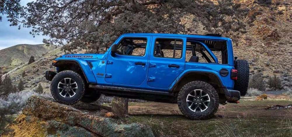 Blue Jeep Elevated on Rock