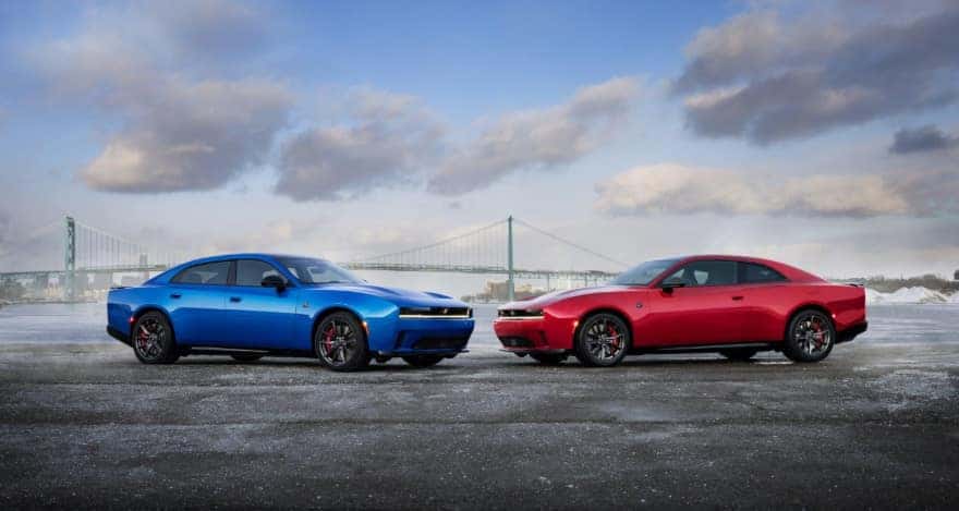 A red and blue Dodge Charger parked on a pier with a bridge in the background.