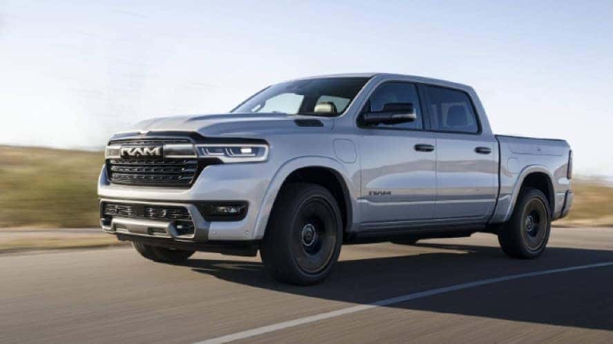 A silver RAM 1500 REV driving down the road.