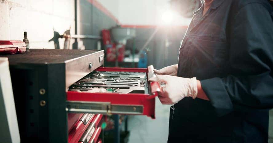 A technician opening up a drawer with their tools.