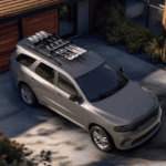 An overhead image of a gray Dodge Durango with skis on the roof in a driveway.