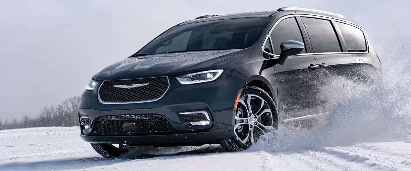The 2024 Chrysler Pacifica Pinnacle being driven on a snow-covered surface.