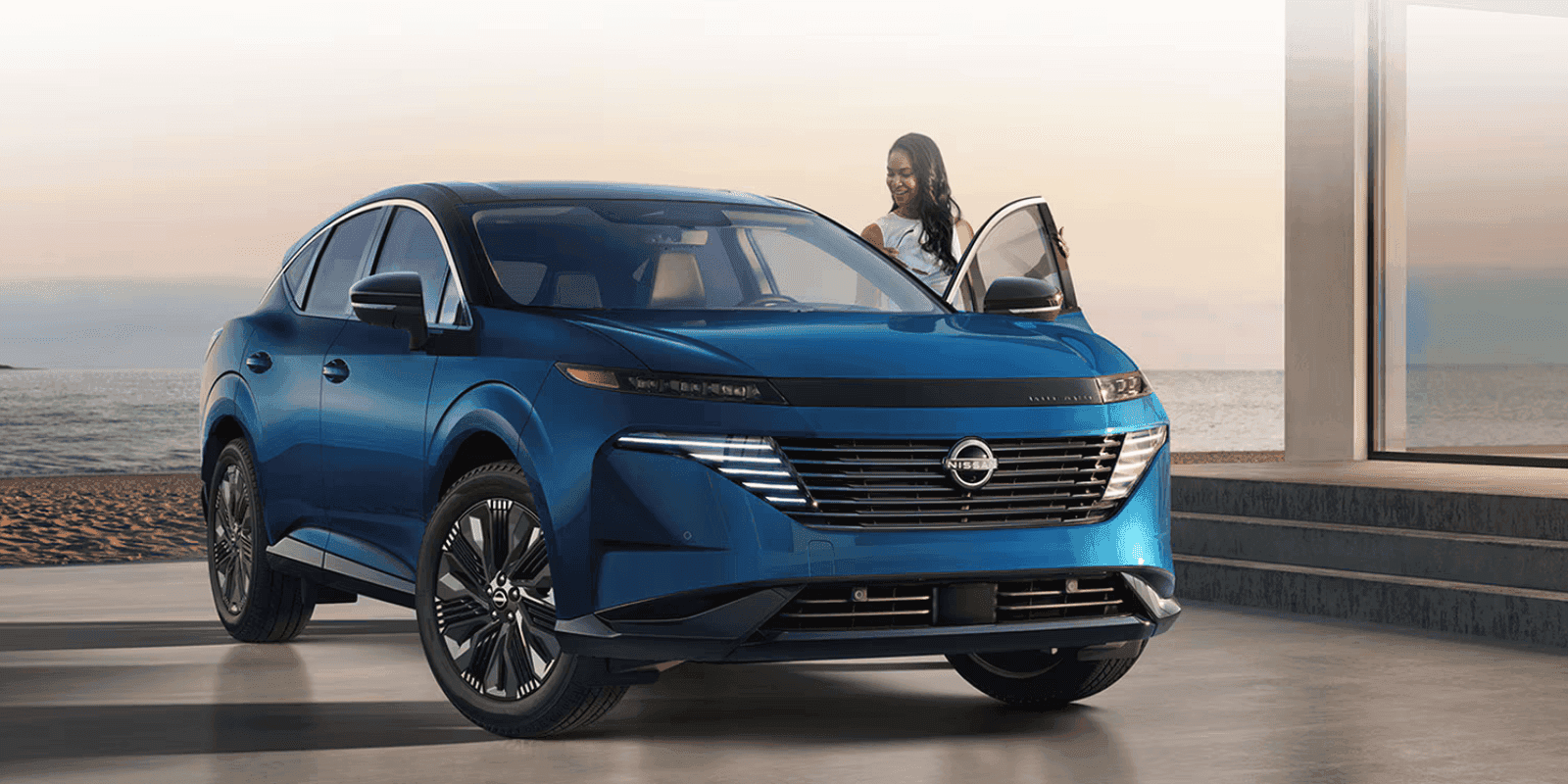 A woman entering the driver seat of a Blue Nissan Kicks