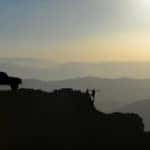 People and Jeep Wrangler on Mountain top