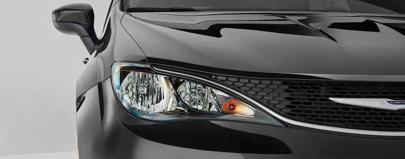 A close up is shown of the passenger headlight on a 2021 Chrysler Voyager.