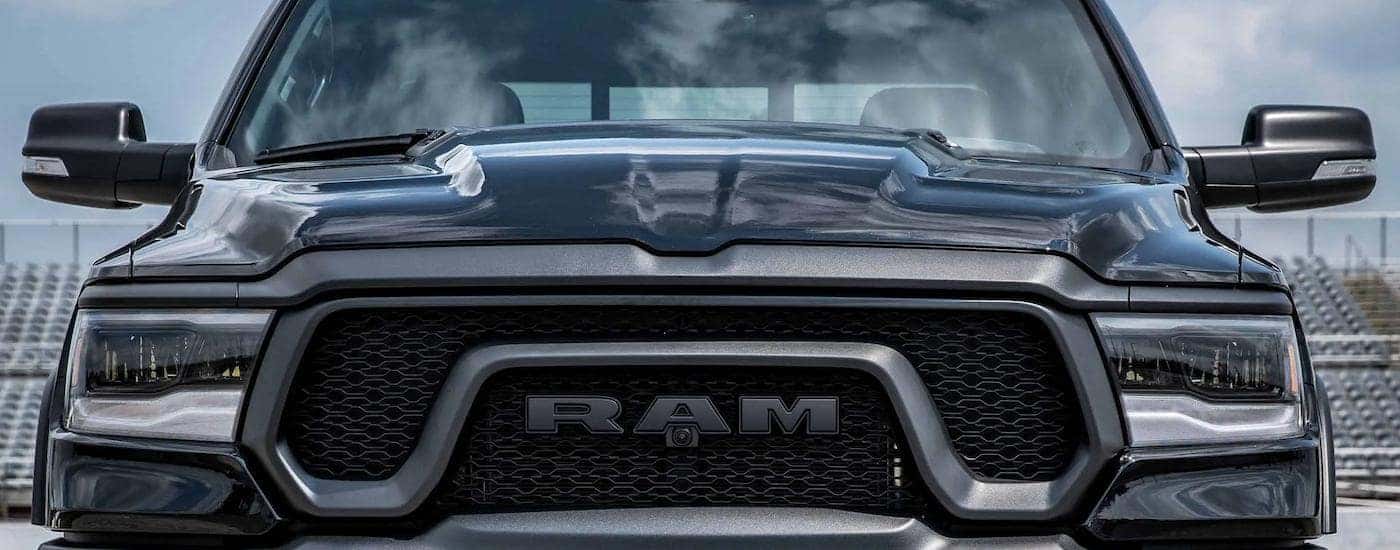 A close up of the grille on a black 2023 Ram 1500 Rebel for sale is shown.