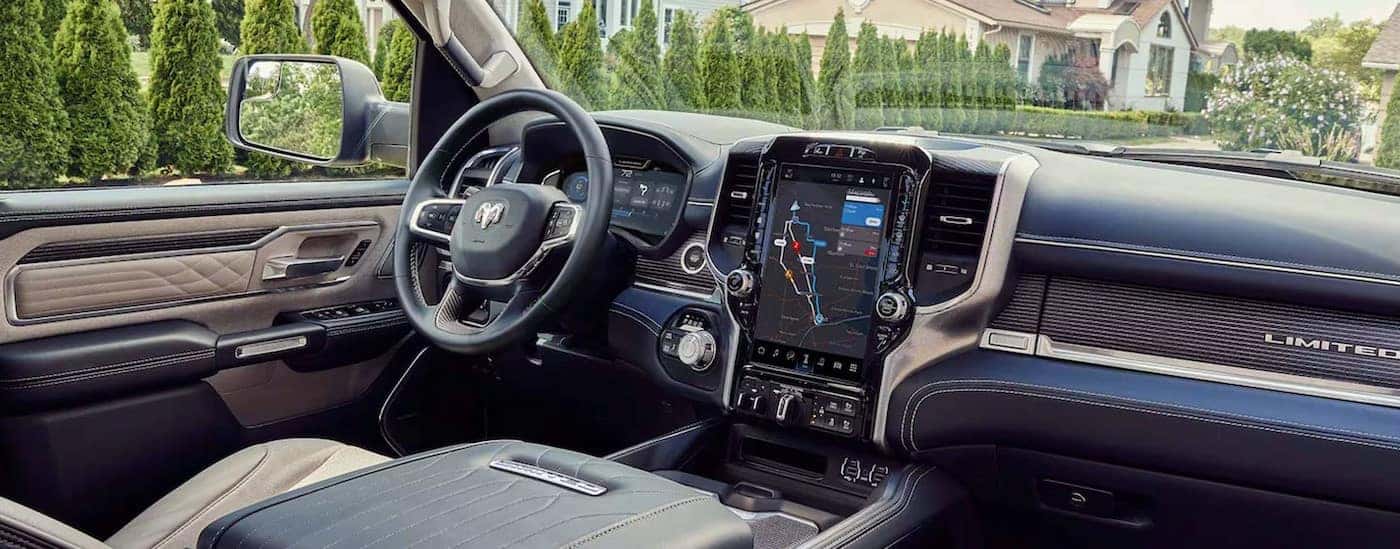 The black and tan interior and dash in a 2024 Ram 1500 Limited is shown.