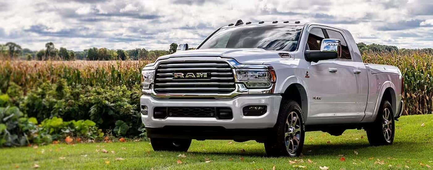 A white 2024 Ram 2500 parked on a farm.