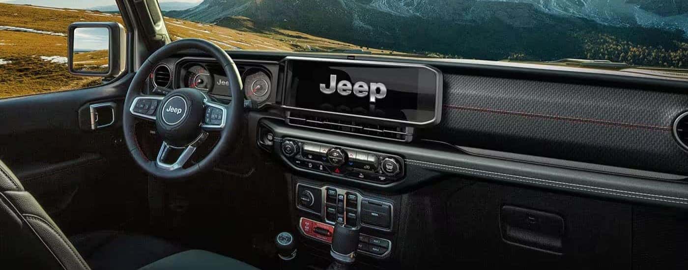 The black interior and dash in a 2024 Jeep Wrangler is shown.