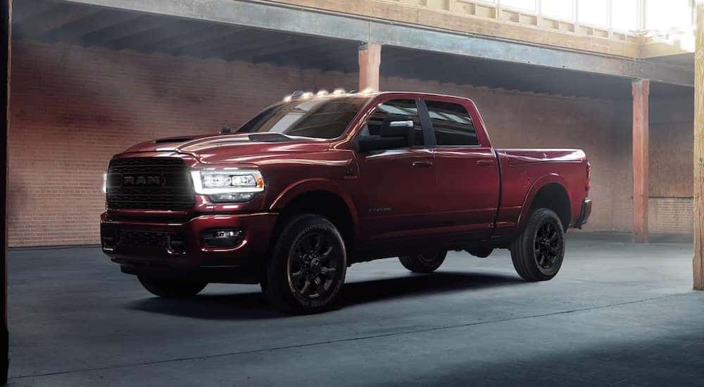 A red 2024 Ram 2500 Limited is shown from the front at an angle after leaving a dealer that has a Ram 2500 for sale near Somerset.