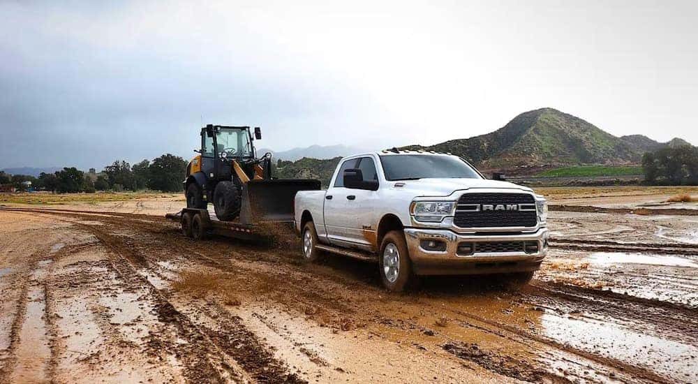 A white 2024 Ram 2500 Big Horn is shown from the front at an angle.