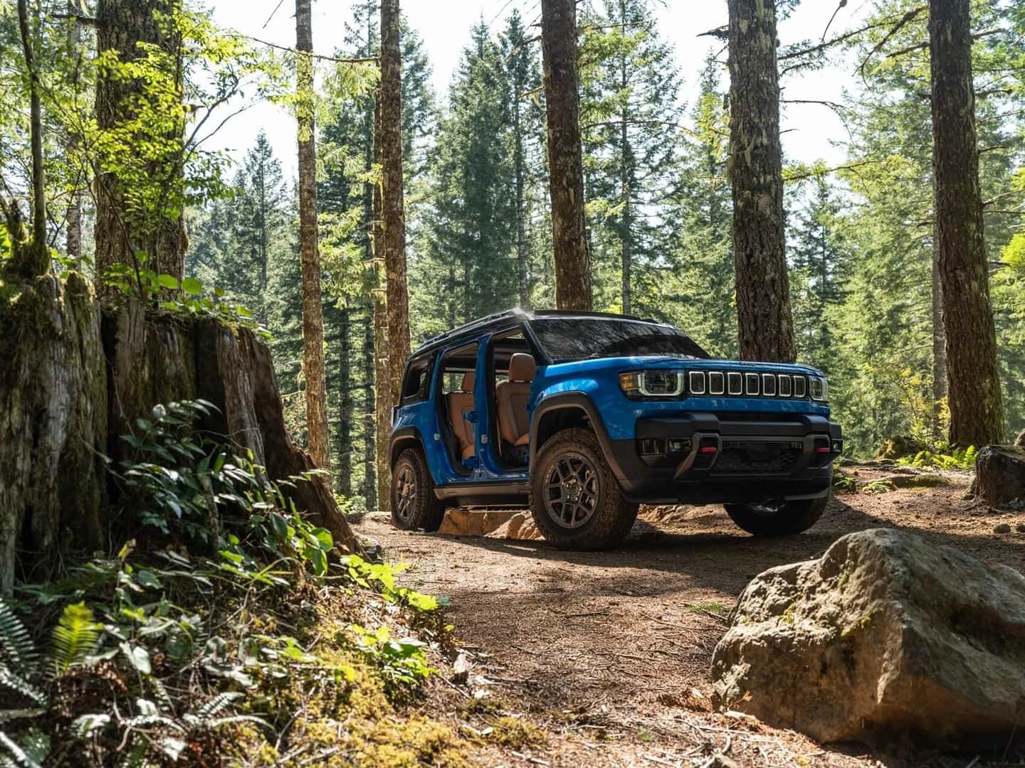 2027 Blue Jeep Recon EV in the woods