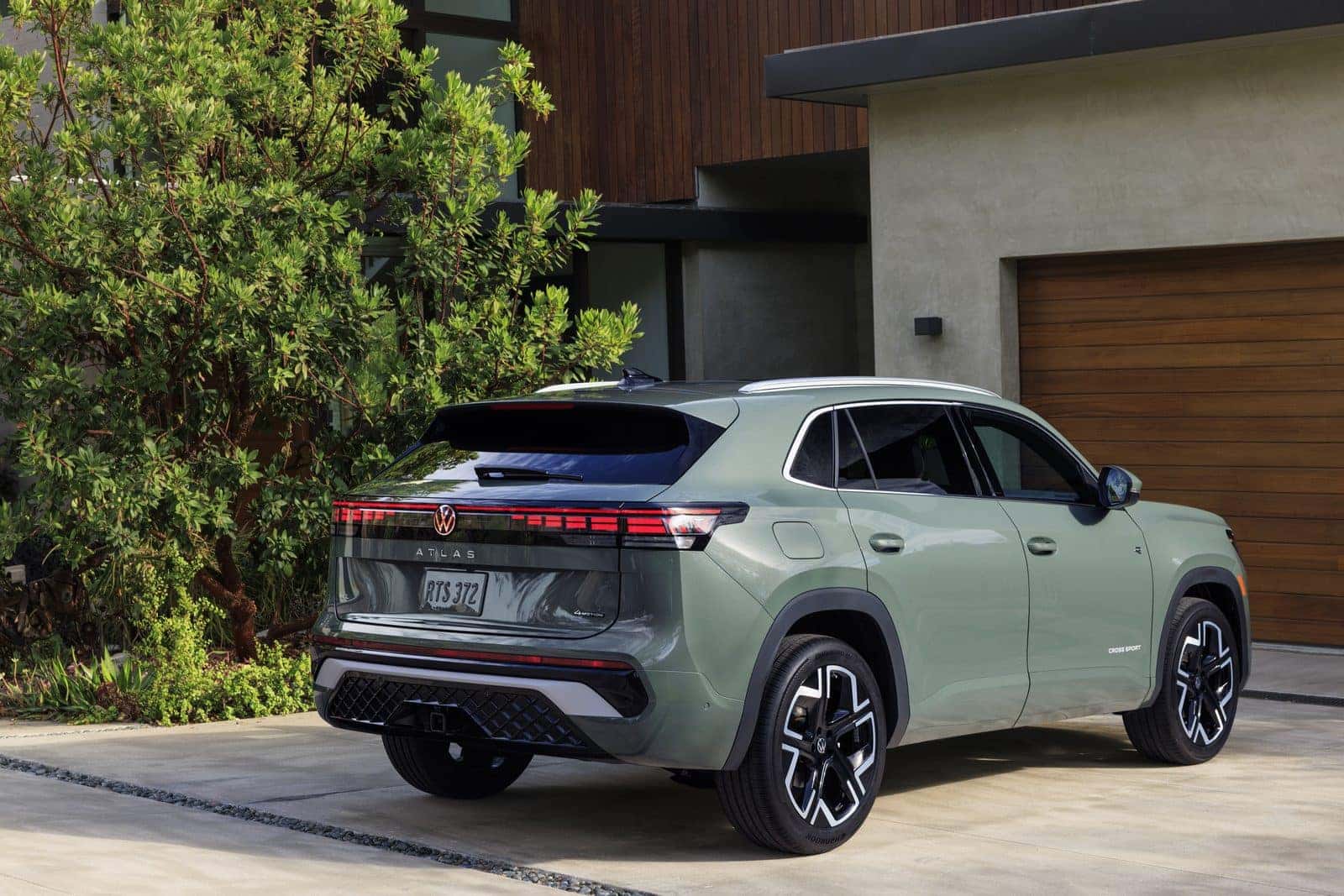 Rear three-quarter view of the 2027 Volkswagen Atlas Cross Sport showing the cross-body taillight design and flush tailgate