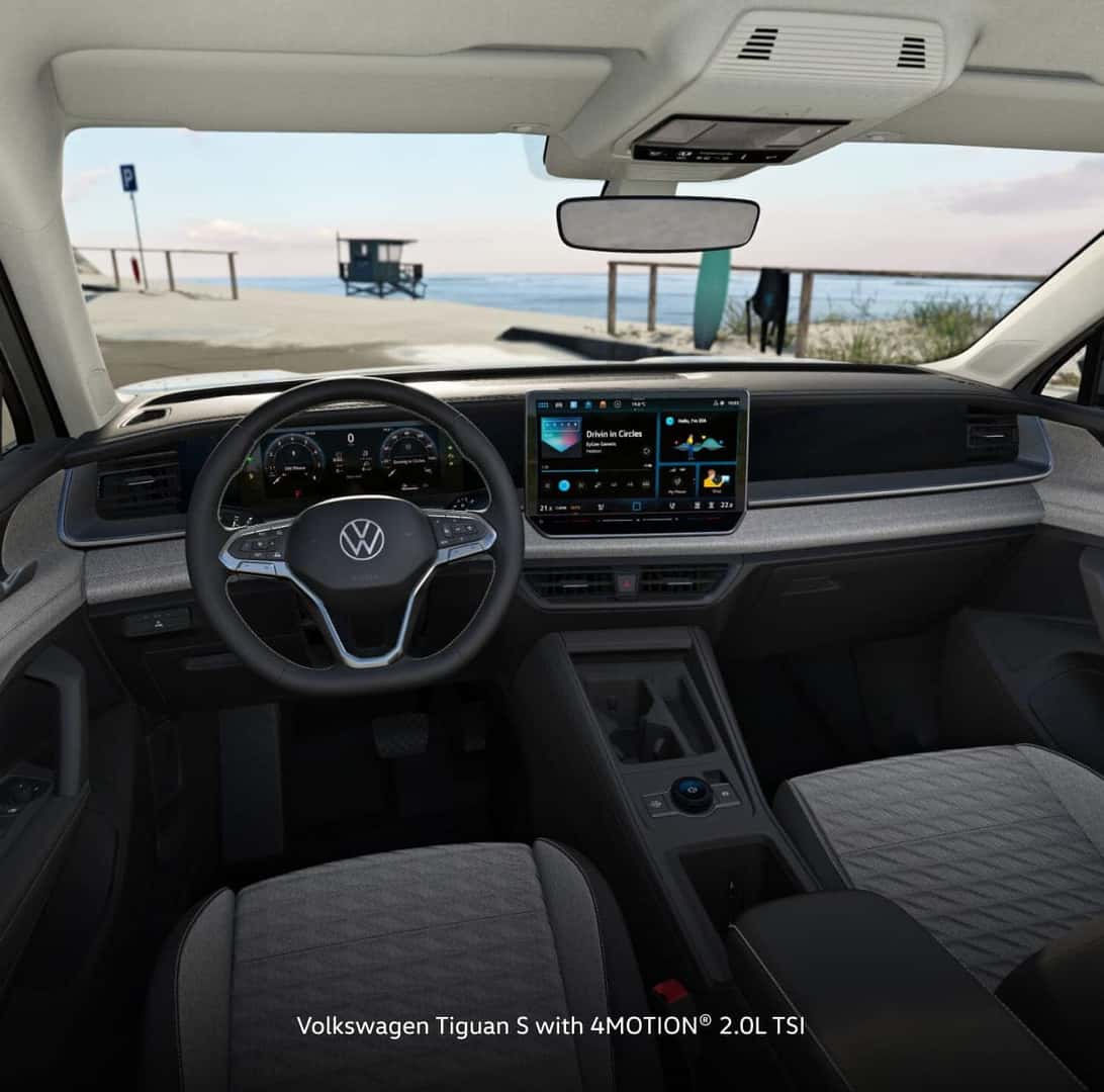 Interior of a Volkswagen Tiguan S with 4MOTION, featuring a sleek dashboard with a digital display.