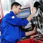 mechanic aligning tires