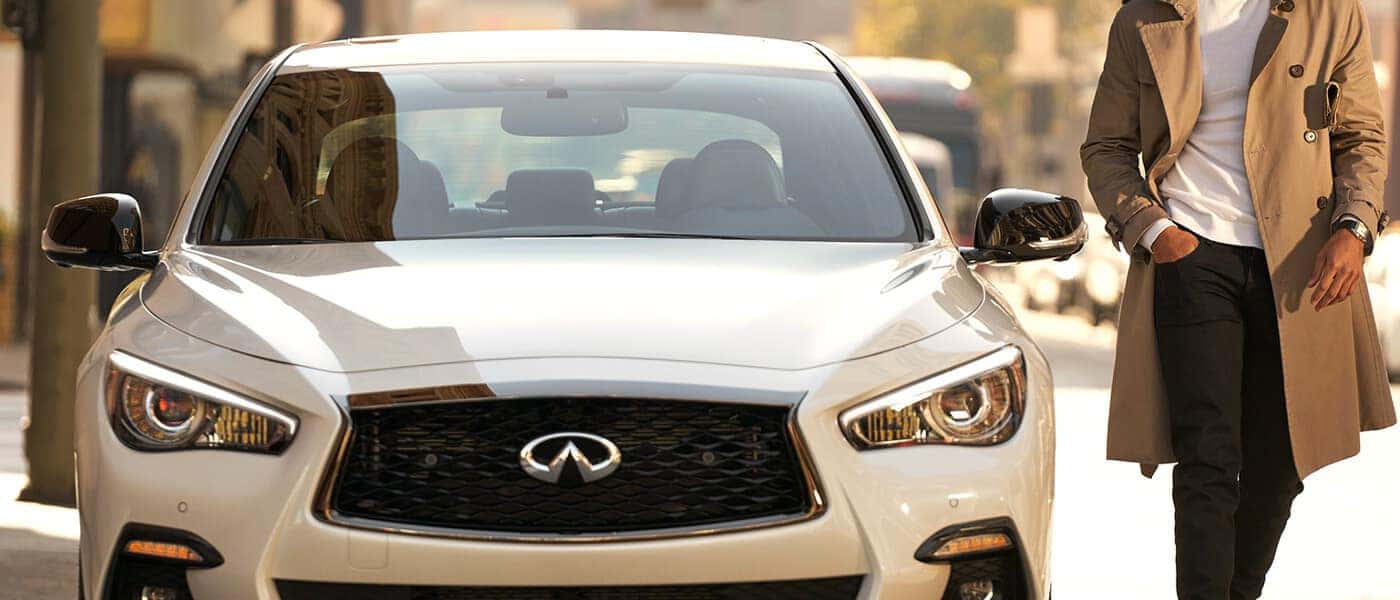 2020 INFINITI Q50 A man walking from his 2020 INFINITI Q50