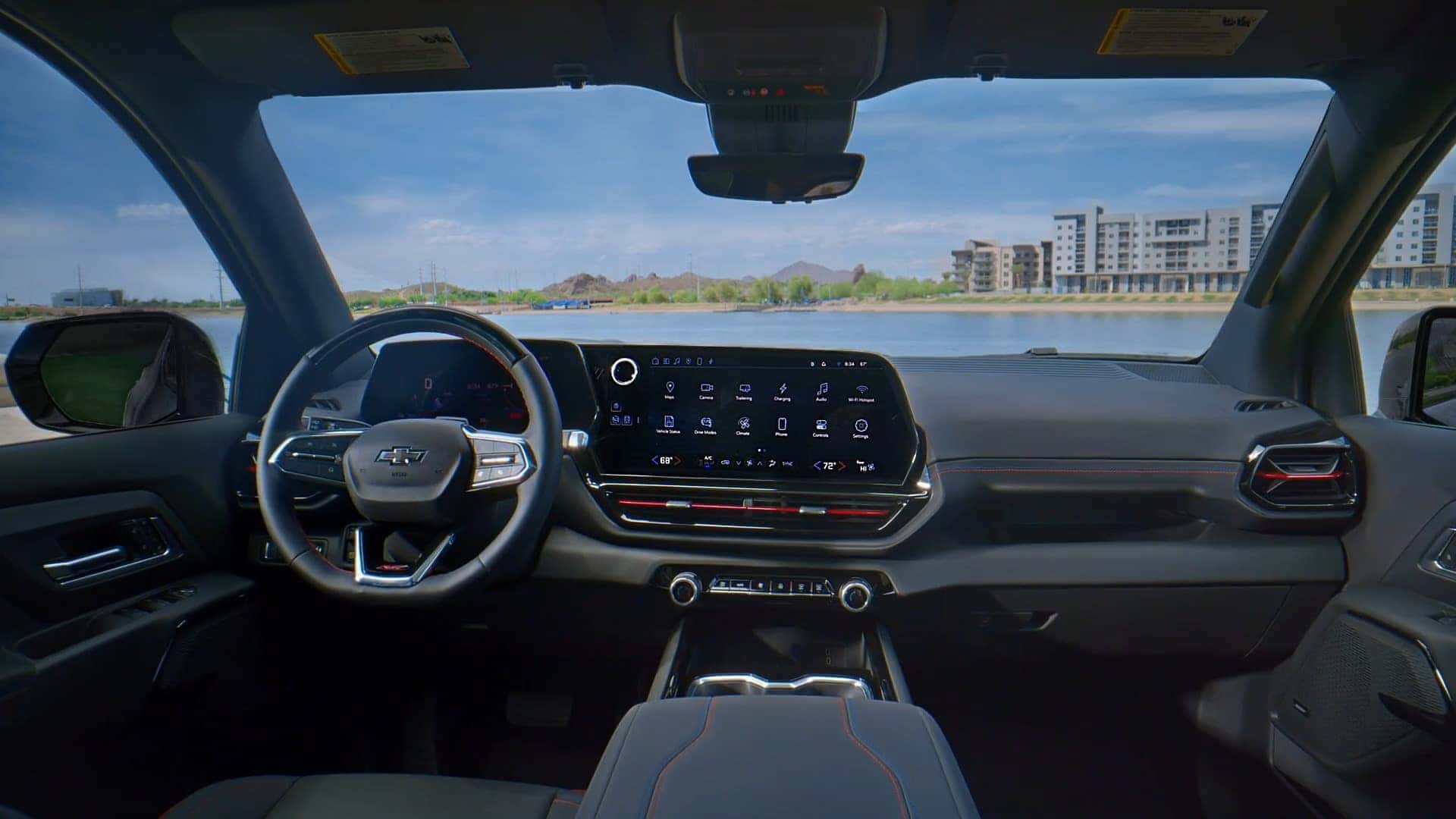 Interior view of a Chevrolet Silverado EV with a scenic lake view through the windshield.