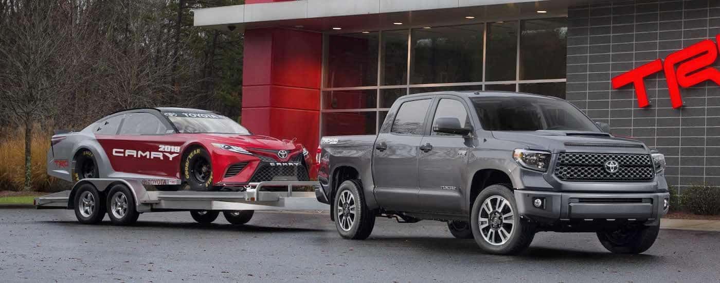 Silver 2018 Toyota Tundra tows a Camry race car