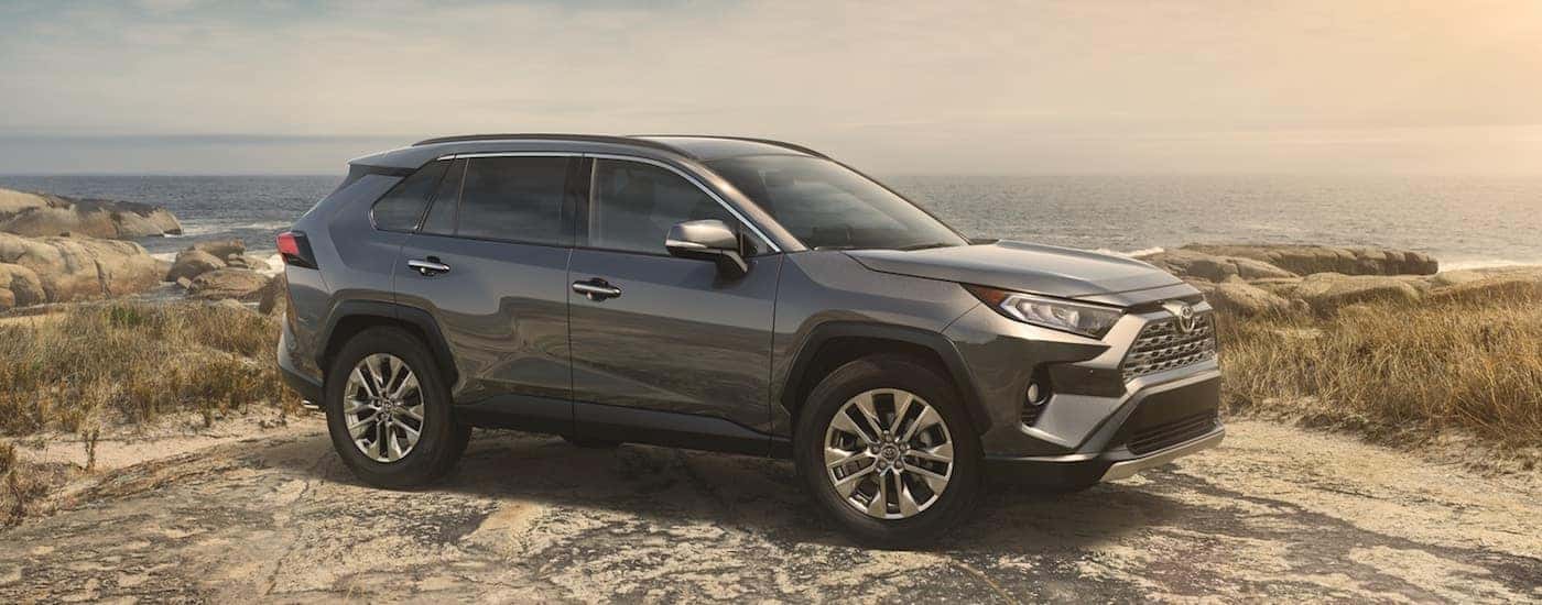Gray 2019 Toyota Rav4 on rock at beach